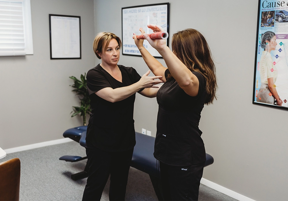 Dr. Jess Bruin assisting a patient at Action Wellness